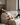 A_man_with_flu_symptoms_lying_on_a_sofa_with_a_cold_compress_and_lemon_tea