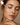 A woman with closed eyes applies serum to her freckled face for skincare, enhancing natural beauty.