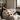 A_man_with_flu_symptoms_lying_on_a_sofa_with_a_cold_compress_and_lemon_tea