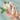 Intimate health care product held in hands with a white flower in the background