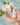 Intimate health care product held in hands with a white flower in the background